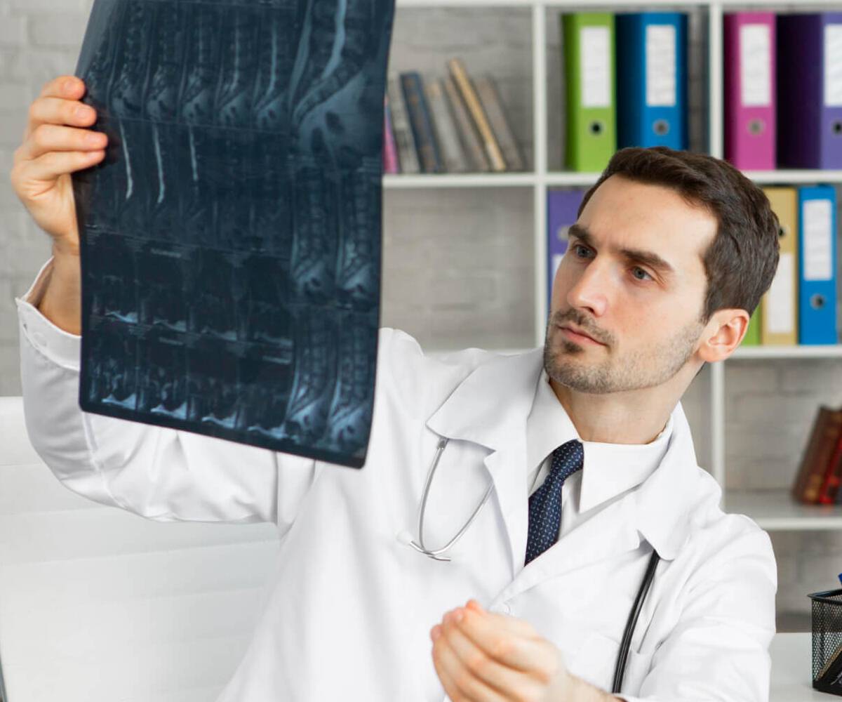 The dentist is reviewing the dental imaging results for the patient.